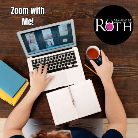 woman's arms on table with laptop open and zoom call in progress